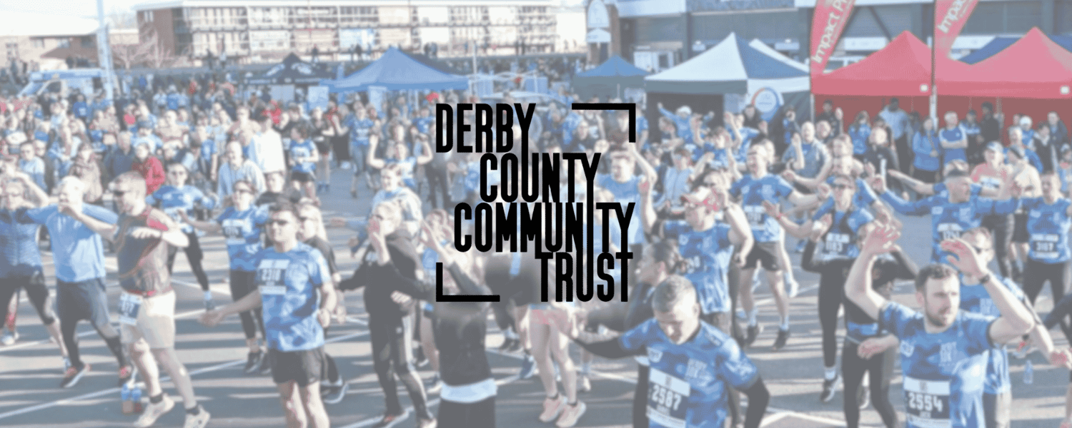 Runners warming up for the Derby 10k with the Derby County Community Trust logo over the top of the image